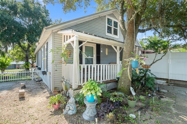 view of side of home with covered porch