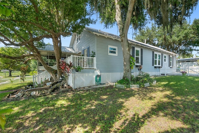 view of side of home with a yard