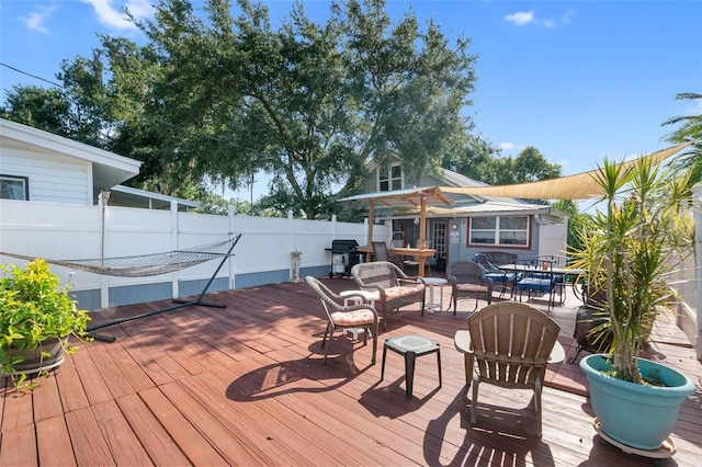 wooden terrace featuring grilling area