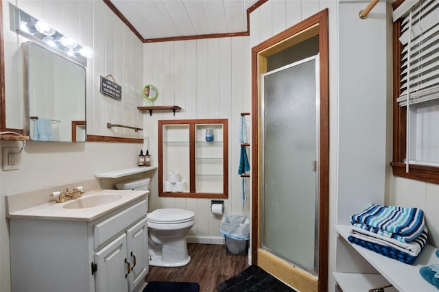 bathroom featuring walk in shower, toilet, ornamental molding, vanity, and hardwood / wood-style flooring