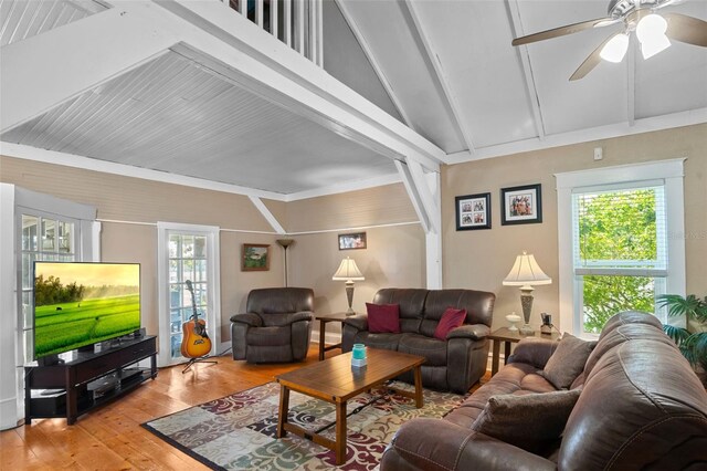 living room with ceiling fan, vaulted ceiling, light hardwood / wood-style flooring, and plenty of natural light