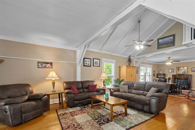 living room with high vaulted ceiling, ceiling fan, light hardwood / wood-style floors, and beam ceiling