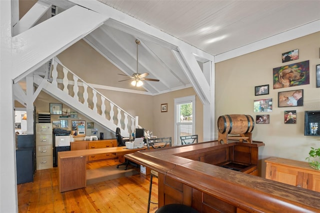 interior space featuring ceiling fan, wood-type flooring, and lofted ceiling with beams