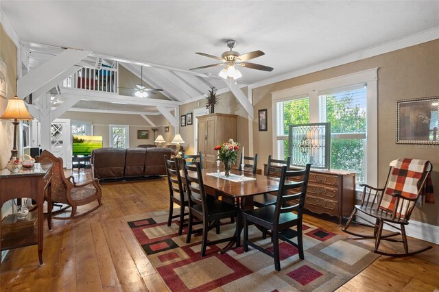 dining space with vaulted ceiling with beams, ceiling fan, and hardwood / wood-style floors