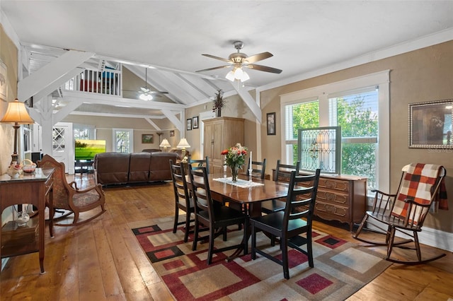 dining room with crown molding, hardwood / wood-style flooring, vaulted ceiling, and ceiling fan