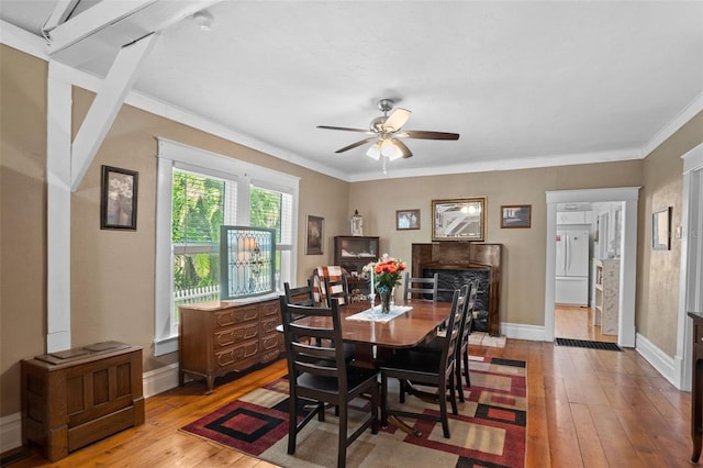 dining space featuring crown molding, light wood-type flooring, and ceiling fan