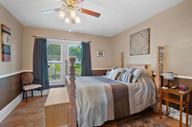 bedroom with ceiling fan and hardwood / wood-style floors