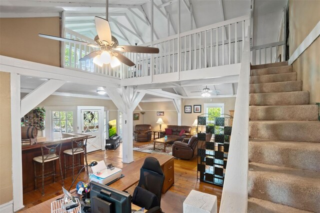 living room with high vaulted ceiling, ceiling fan, hardwood / wood-style flooring, and beam ceiling