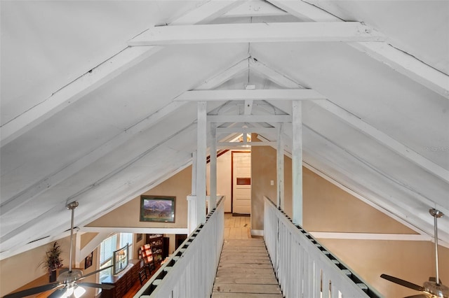 interior space with vaulted ceiling with beams, ceiling fan, and light hardwood / wood-style floors