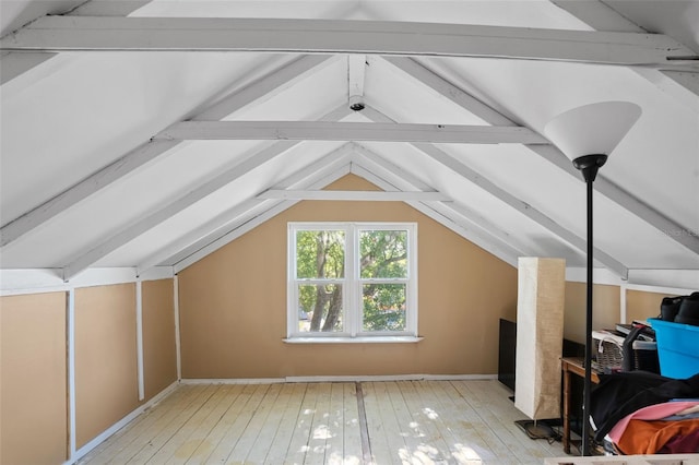 bonus room with vaulted ceiling with beams and light hardwood / wood-style flooring