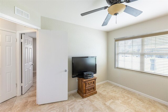 interior space with ceiling fan