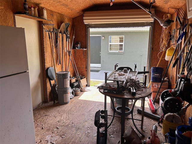 miscellaneous room featuring wood-type flooring and lofted ceiling