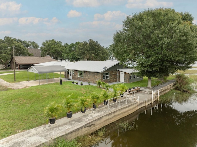 back of property featuring a yard and a water view