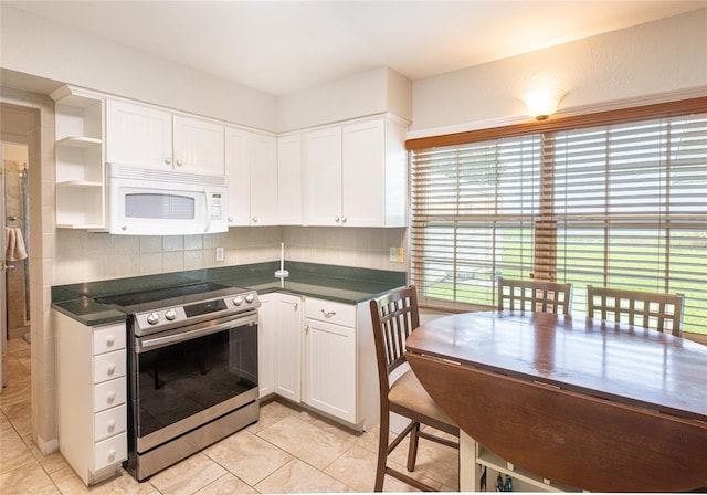 kitchen featuring white cabinetry, tasteful backsplash, light tile patterned flooring, and stainless steel range with electric cooktop