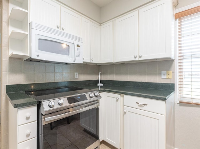 kitchen featuring stainless steel electric range and white cabinets