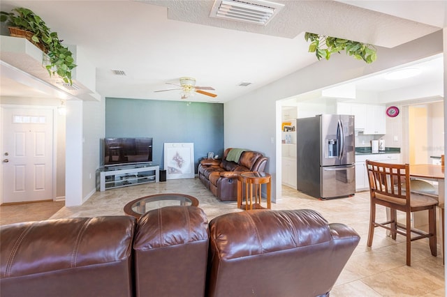 living room with ceiling fan and light tile patterned floors