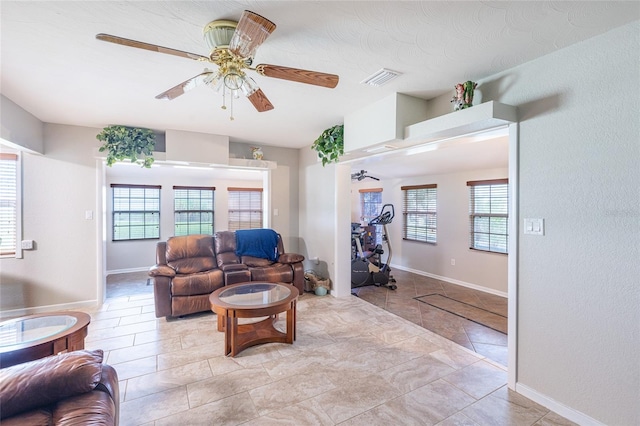 living room with plenty of natural light and ceiling fan