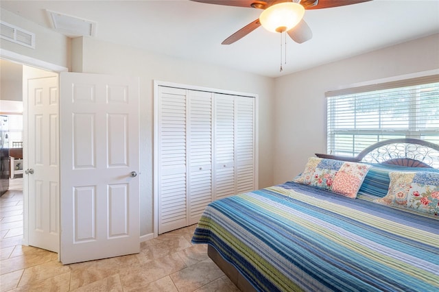 tiled bedroom with a closet and ceiling fan