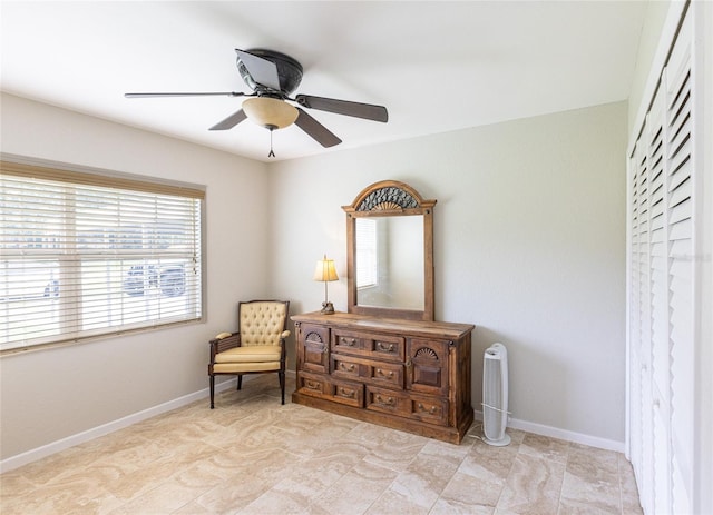 sitting room featuring ceiling fan