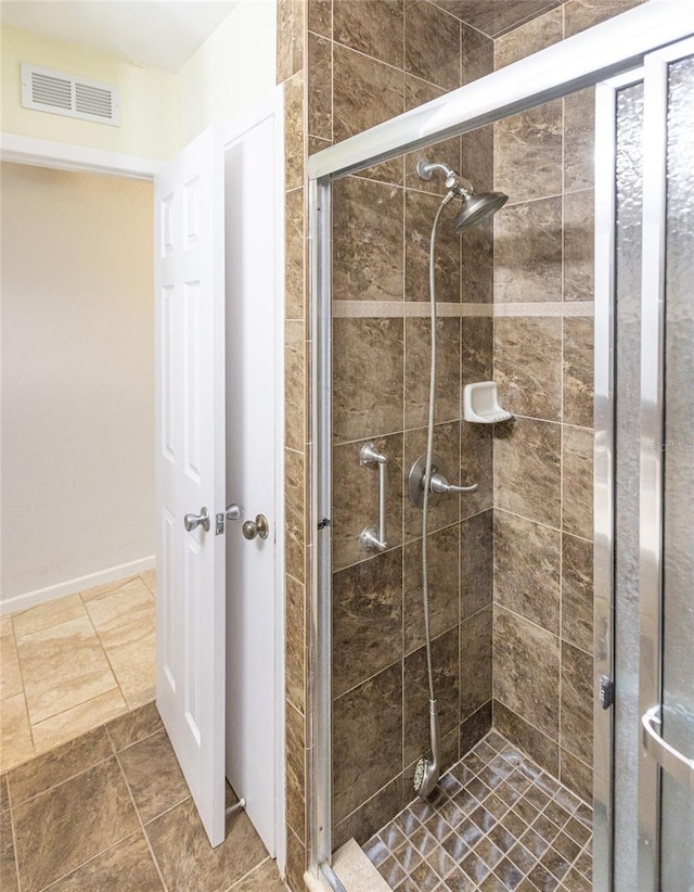 bathroom featuring a shower with door