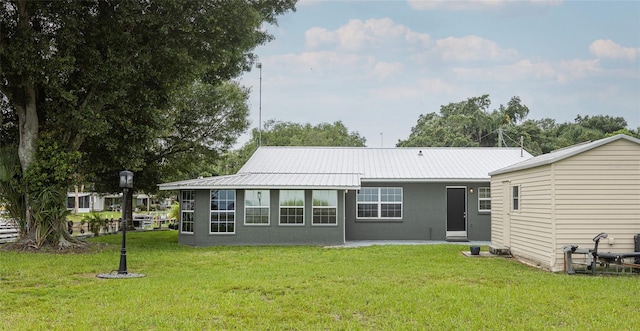 rear view of property with a yard