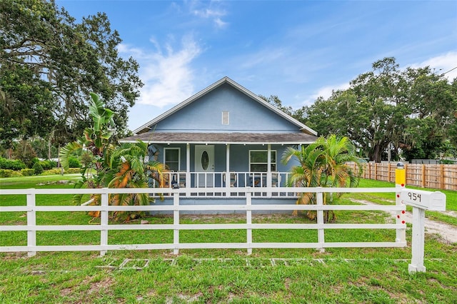 view of front of property with covered porch and a front lawn