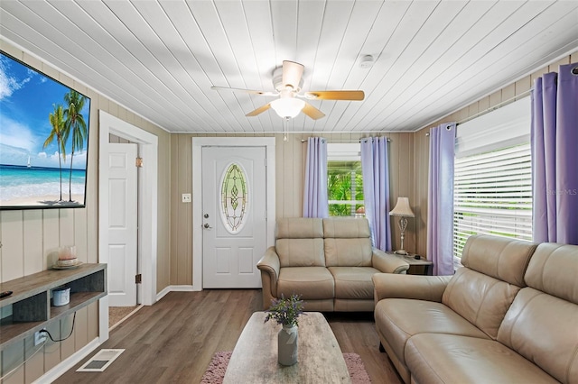 living room with wood-type flooring, wooden ceiling, and ceiling fan