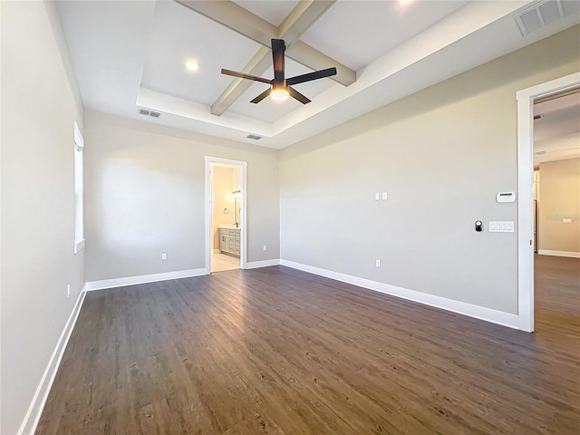 empty room featuring a tray ceiling, ceiling fan, beamed ceiling, and dark wood-type flooring