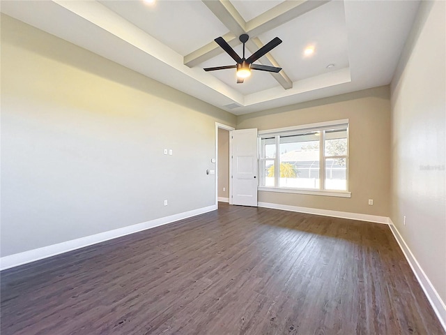 empty room with beam ceiling, ceiling fan, dark hardwood / wood-style flooring, and a tray ceiling