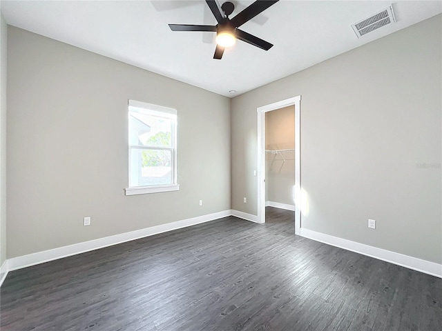 spare room featuring dark hardwood / wood-style floors and ceiling fan