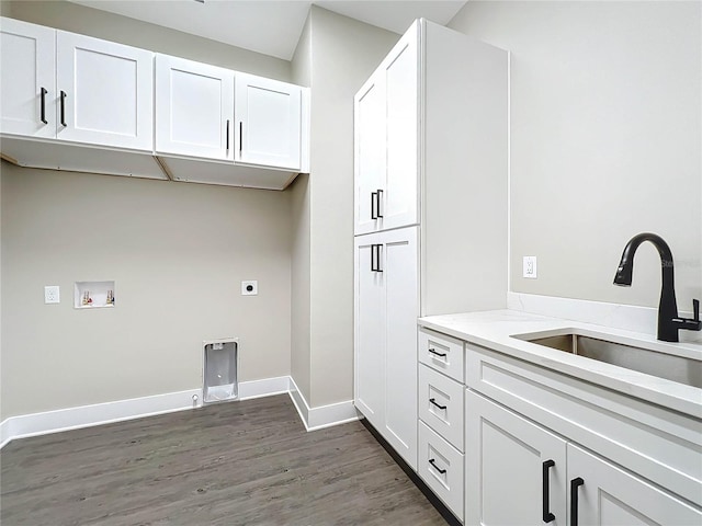 clothes washing area featuring cabinets, washer hookup, dark hardwood / wood-style flooring, hookup for an electric dryer, and sink