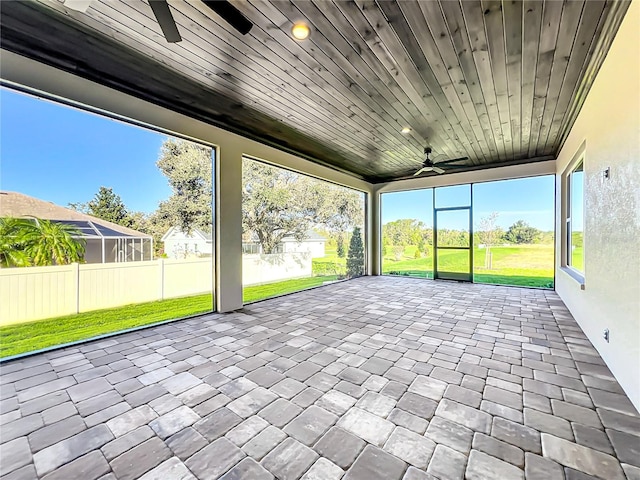 unfurnished sunroom featuring ceiling fan and wood ceiling