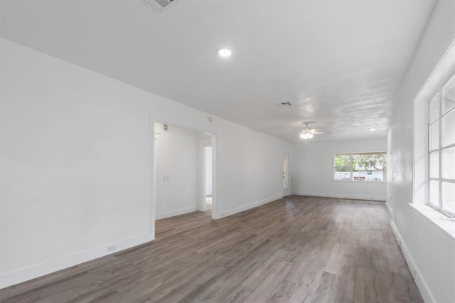 unfurnished room with ceiling fan and wood-type flooring