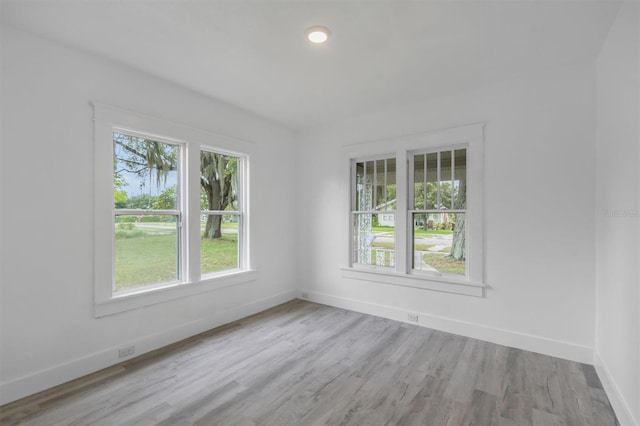 spare room with light hardwood / wood-style floors