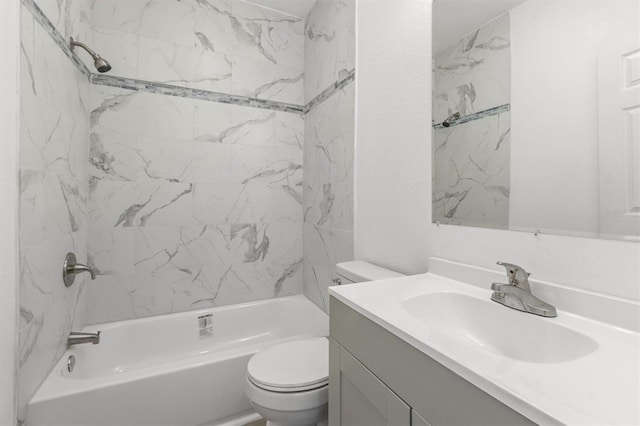 full bathroom featuring tiled shower / bath combo, vanity, and toilet