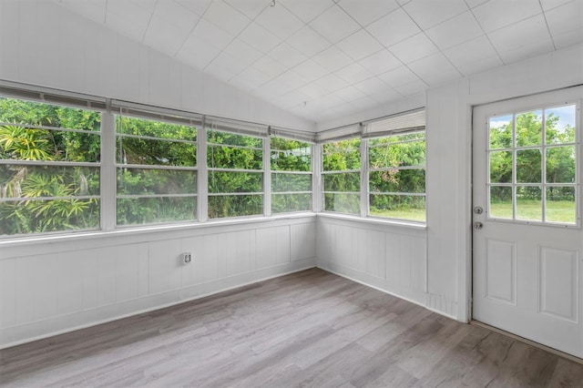 unfurnished sunroom featuring lofted ceiling and a wealth of natural light