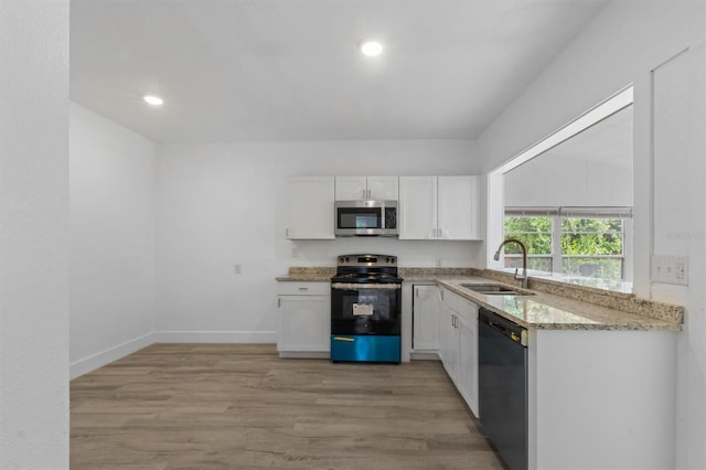 kitchen featuring white cabinetry, black dishwasher, electric range oven, and sink