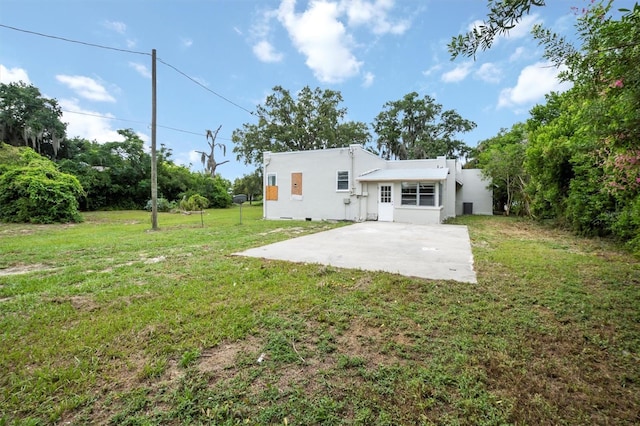 back of house featuring a yard and a patio area