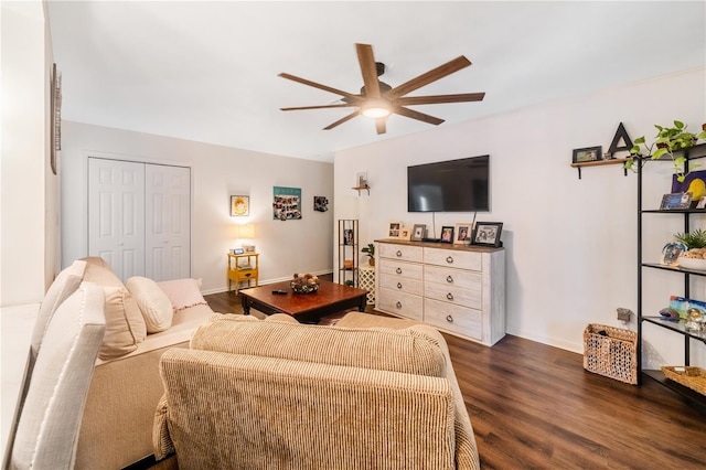 living room with dark hardwood / wood-style flooring and ceiling fan