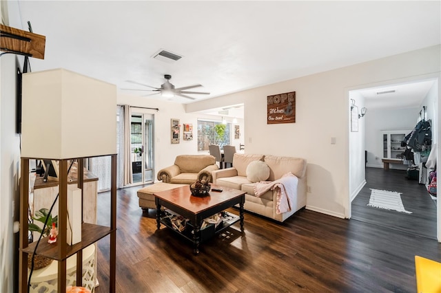 living room featuring dark hardwood / wood-style flooring and ceiling fan