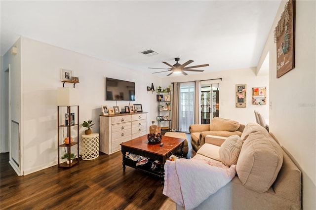 living room with ceiling fan and dark hardwood / wood-style floors