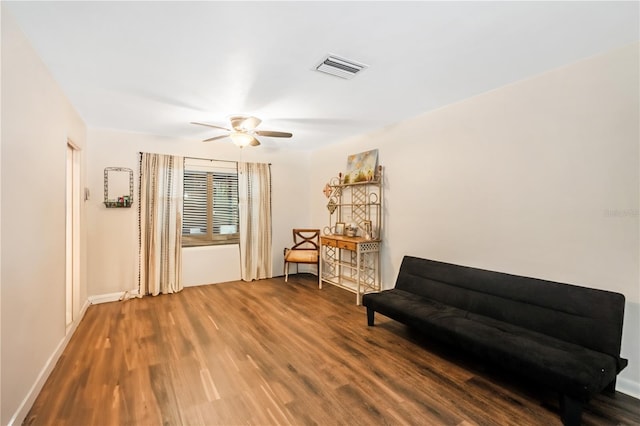 sitting room featuring hardwood / wood-style floors and ceiling fan