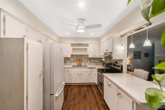 kitchen with white fridge, tasteful backsplash, dark hardwood / wood-style flooring, sink, and stainless steel range with electric stovetop