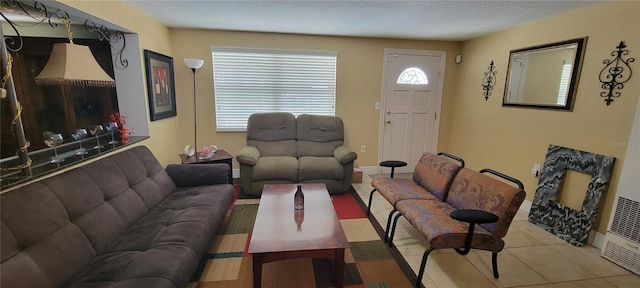 living area with tile patterned flooring and baseboards