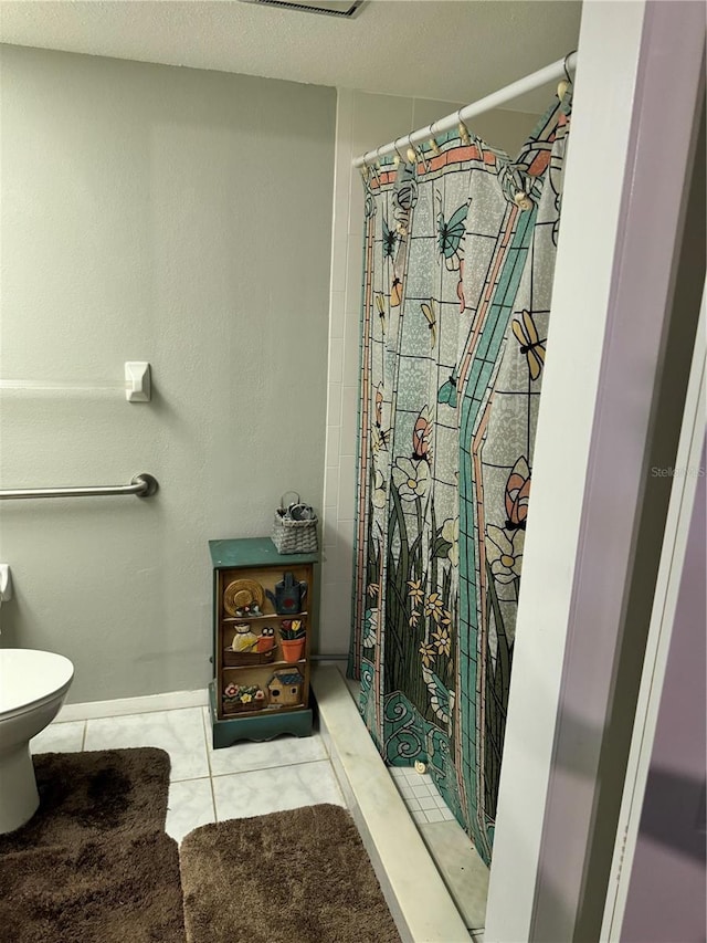 bathroom with tile patterned floors, toilet, and a shower with shower curtain