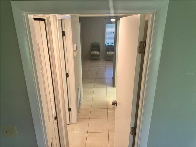 corridor featuring light tile patterned floors