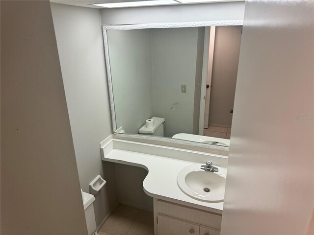 bathroom featuring tile patterned floors, vanity, and toilet