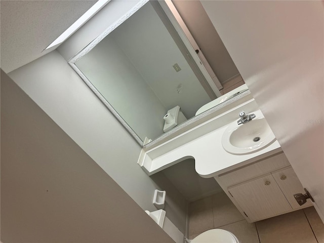 bathroom with vanity, tile patterned floors, and toilet