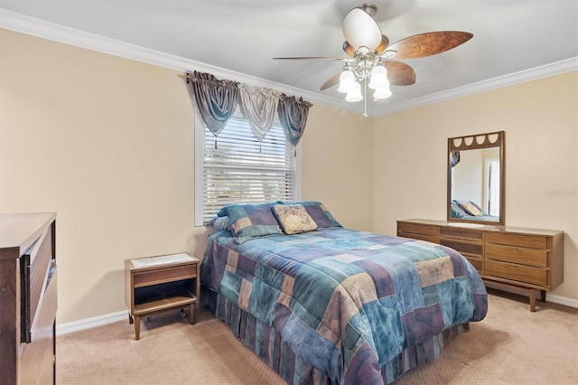 carpeted bedroom featuring ceiling fan and crown molding