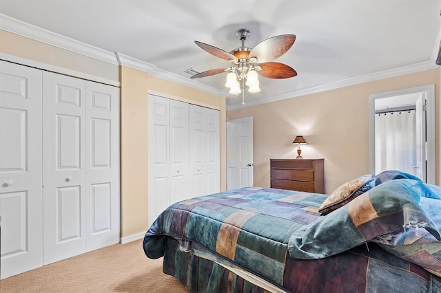 bedroom featuring multiple closets, light carpet, crown molding, and ceiling fan